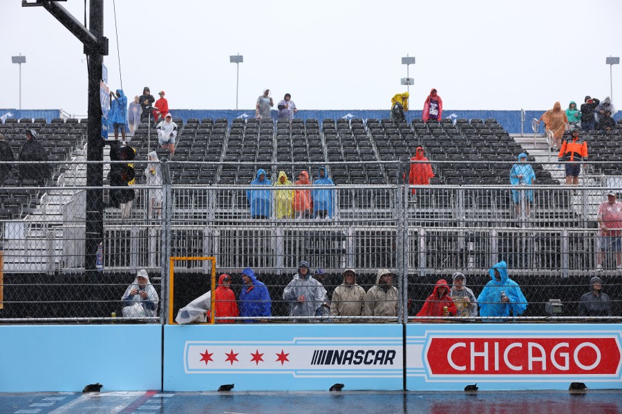 NASCAR fans wait in the rain Sunday afternoon.
