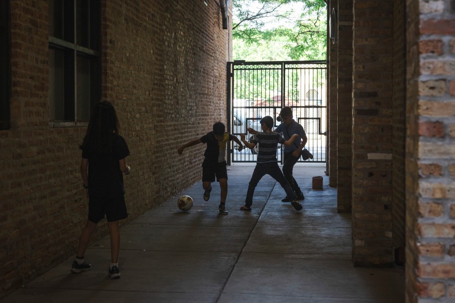 Students play alley soccer during a break from an Arabic language day camp.
