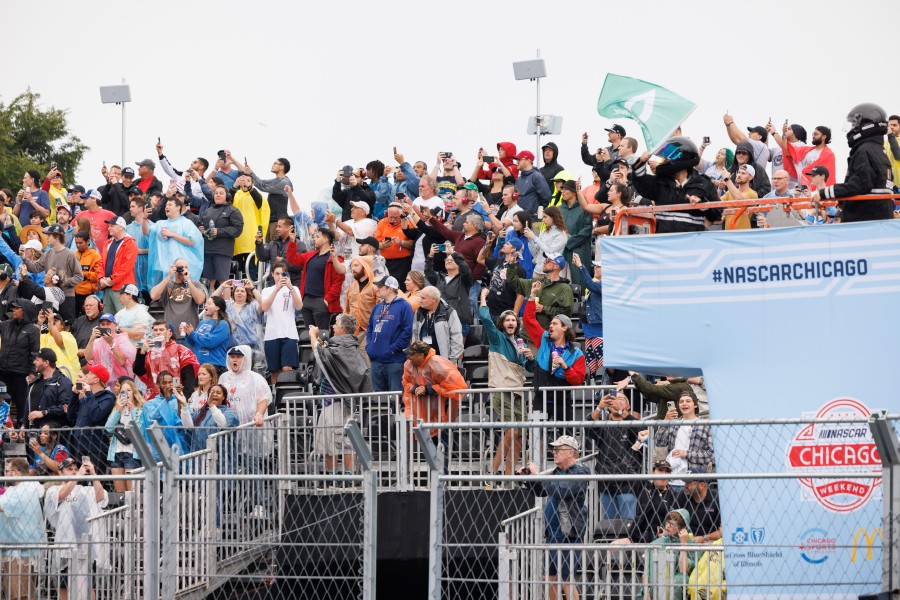 Fans cheer as the green flag is waved to start the race during the Grant Park 220 NASCAR Street Race.