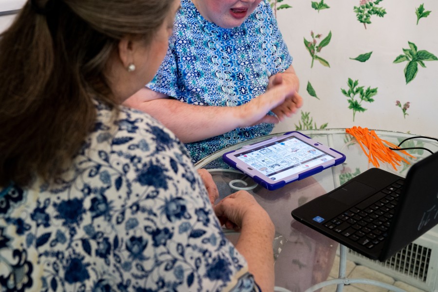 Shofner helps Rachel navigate lessons on her iPad