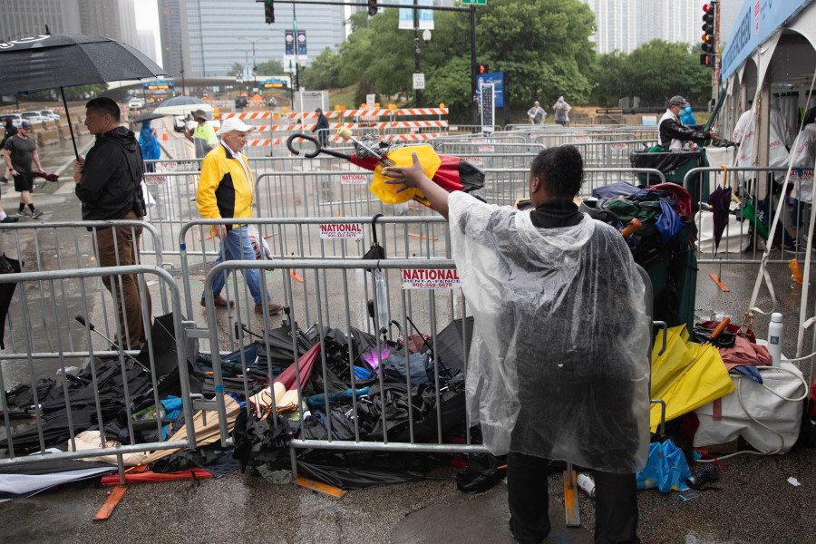 A member of the NASCAR Chicago Street Race safety team drops throwaway umbrellas into a pile on Sunday.