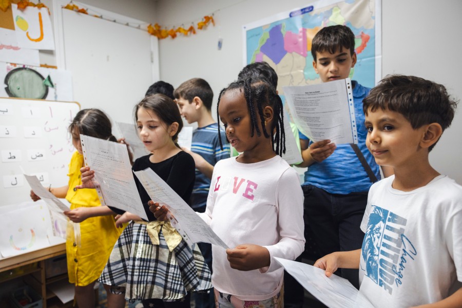 Students practice singing the song they will perform when they finish the program.