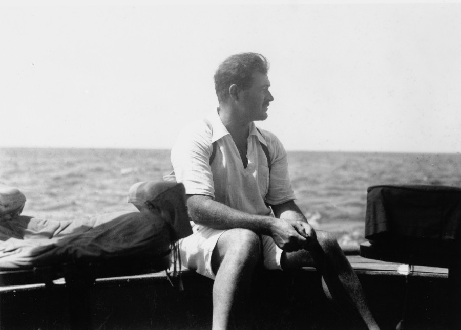 Ernest Hemingway posing at the stern of a boat