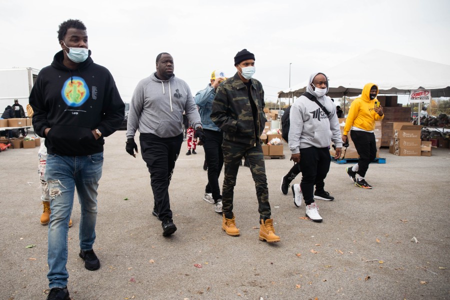 Rapper G Herbo walks from his car to the “Feed Your City Challenge,” a food drive founded by Suave House Records founder Tony Draper and retired NBA player Ricky Davis, in the parking lot of the Pullman Community Center in the Pullman community in 2020.