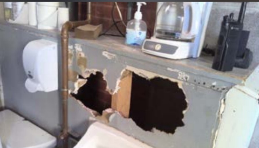 hole in cabinet with coffee pot on top