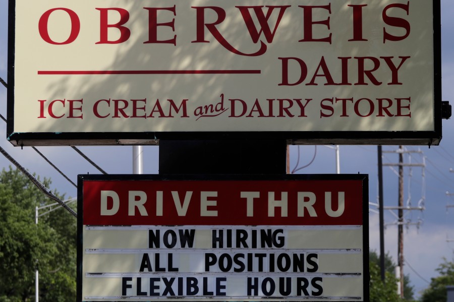 A hiring sign outside of a Oberweis ice cream and dairy store